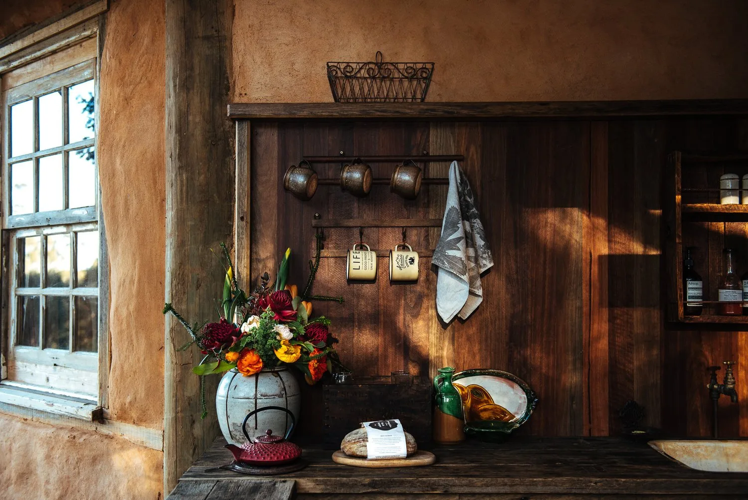 Flowers and small objects on a timber shelf inside Alkira.