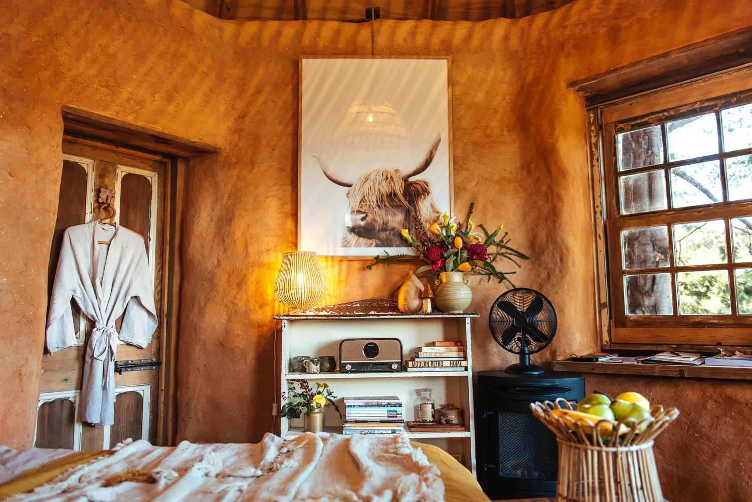 Warm timber walls and windows inside the yurt.