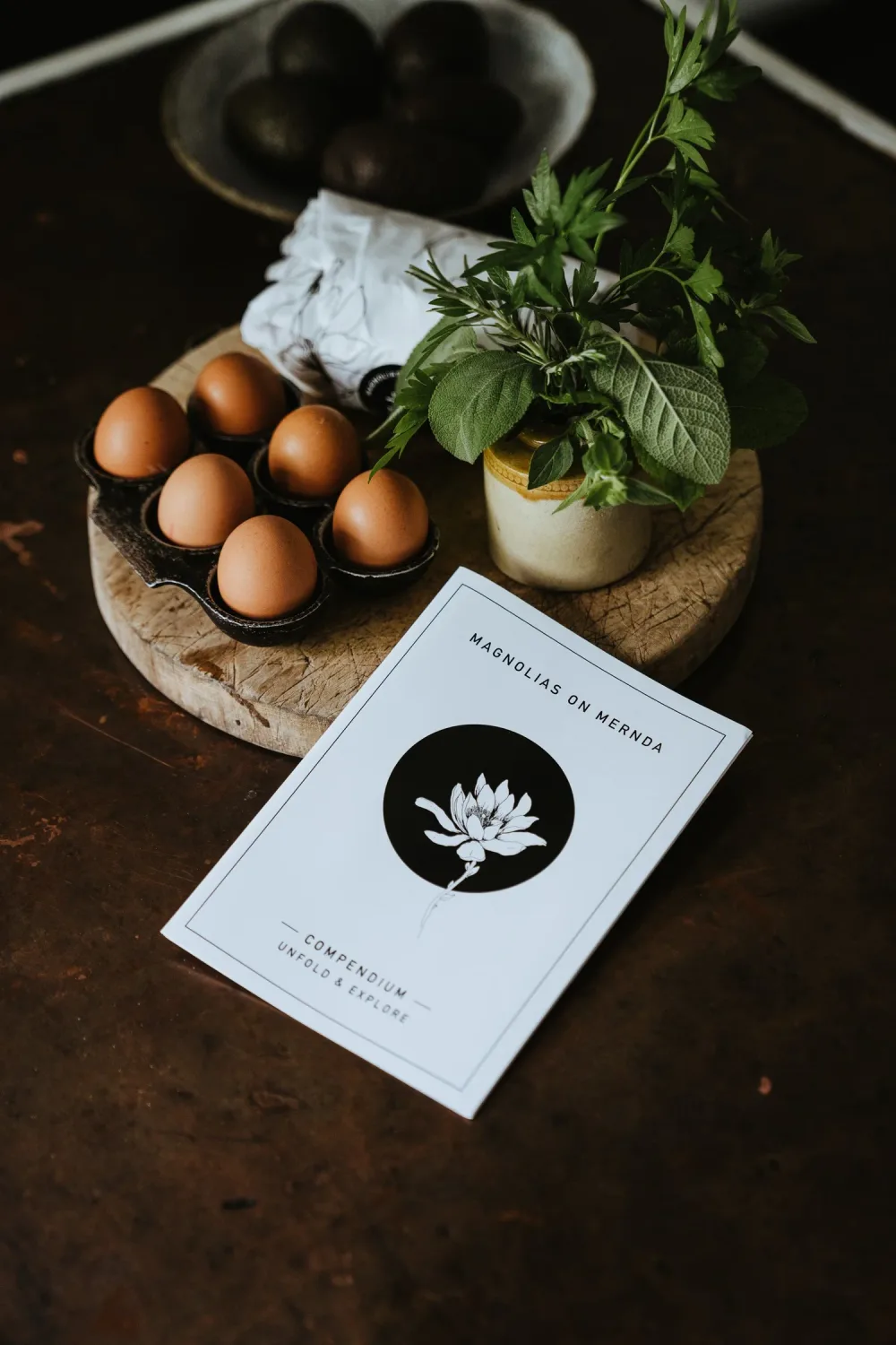 Eggs and a Magnolias on Mernda booklet on a tabletop.
