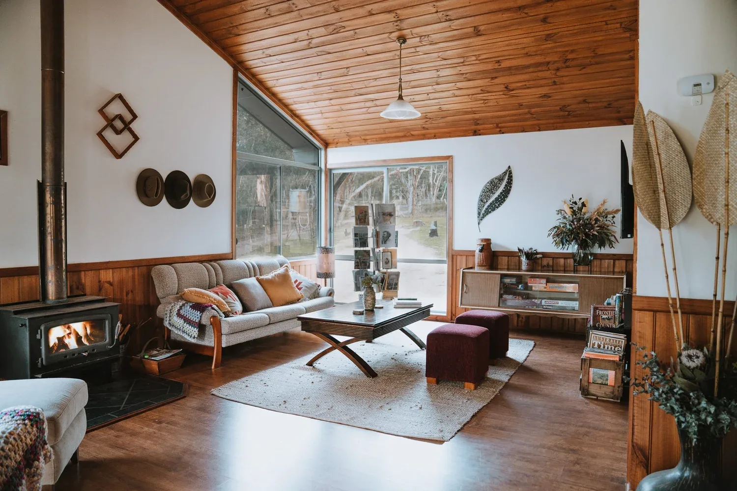 The living room beneath a sloping timber ceiling.