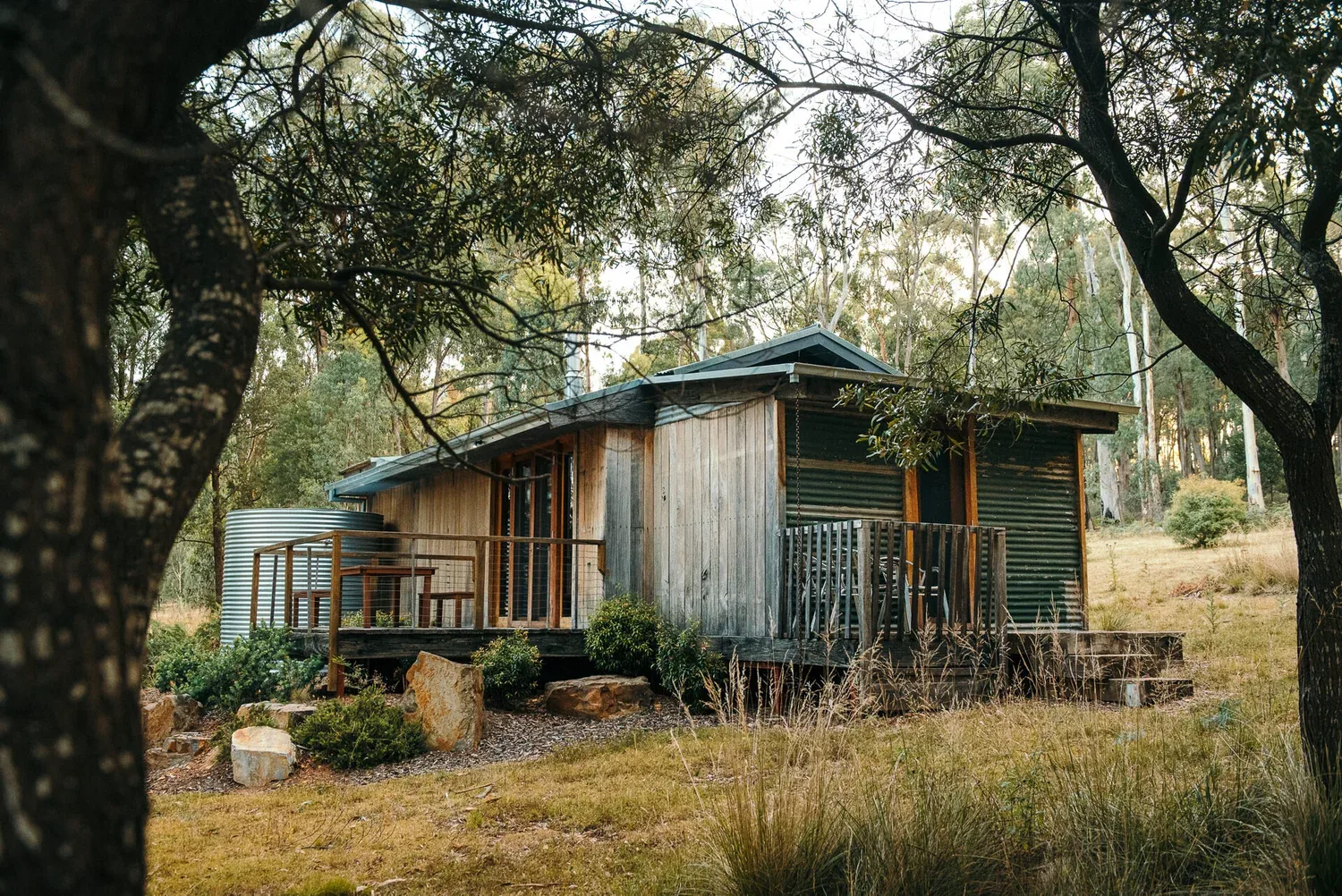 The lodge seen through surrounding trees and grasses.
