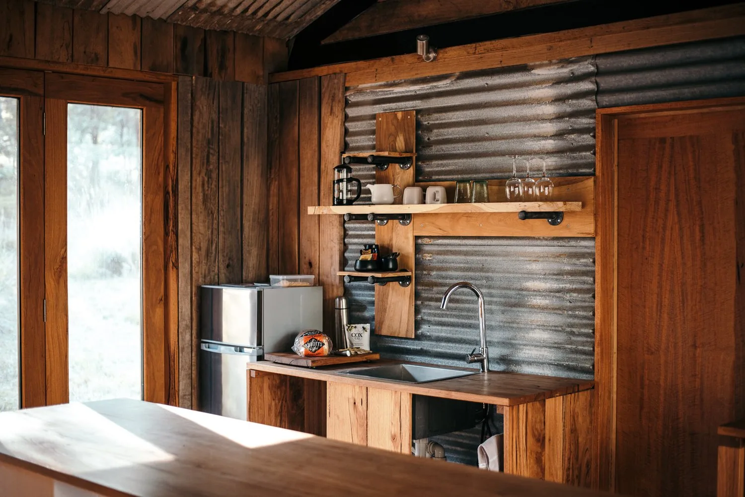 Timber cabinetry and shelves in the kitchen.