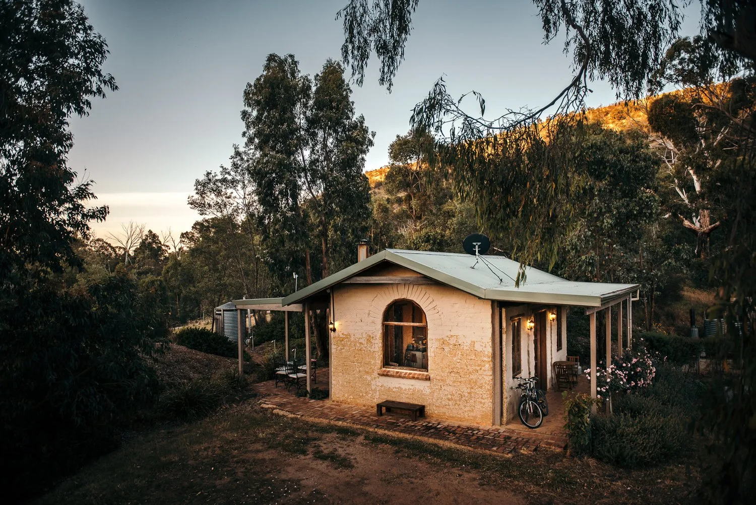 The cottage’s earth-coloured walls and small veranda.