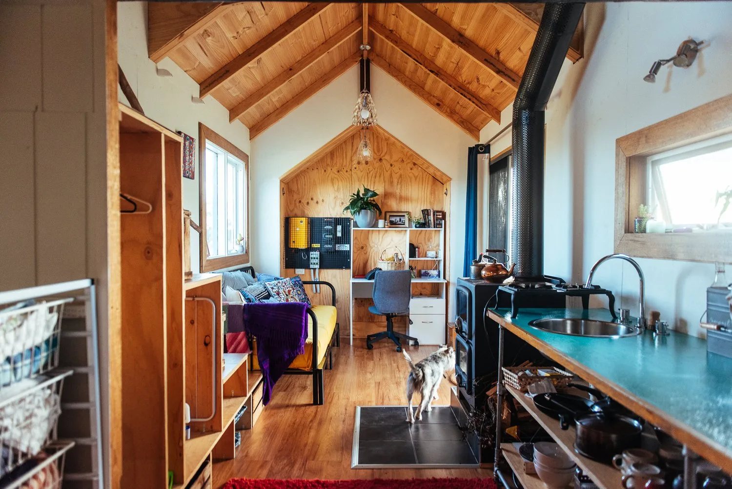 The timber-lined interior and compact kitchen.